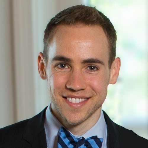 Professor Nicholas Rule wearing a blue shirt, navy jacket and blue and navy striped bowtie